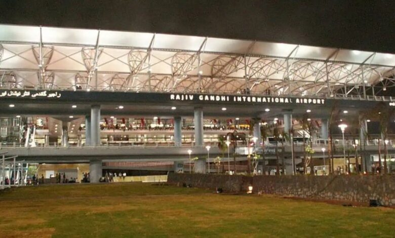 Rajiv Gandhi International Airport at night with illuminated exterior and signage.