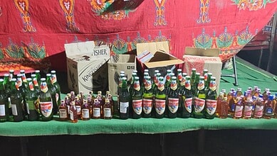 Seized liquor bottles and vehicles displayed during Hyderabad police CASO drive.