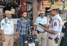 Hyderabad Traffic Police inspecting a bike with a fake number plate.