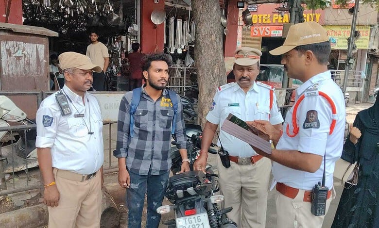 Hyderabad Traffic Police inspecting a bike with a fake number plate.