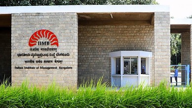 Entrance of IIM Bangalore's overseas campus in Indonesia with logo and greenery.