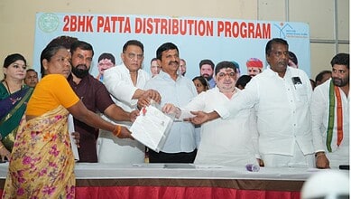 Officials and women participate in 2BHK Patta distribution event in India.