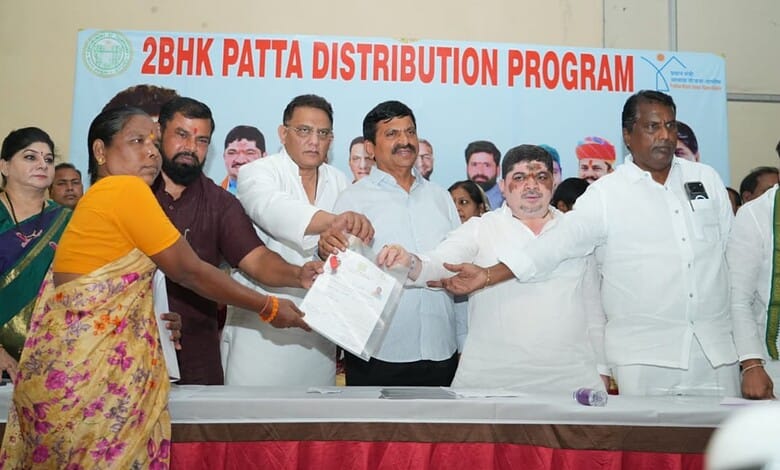 Officials and women participate in 2BHK Patta distribution event in India.