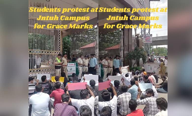 Students protesting over grace marks at JNTU Hyderabad campus, holding banners and placards.