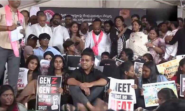 KTR addresses Gen-Z protesters during a rally, surrounded by diverse young demonstrators holding signs.