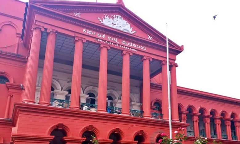 Karnataka High Court building with red facade and classical columns in Bangalore.