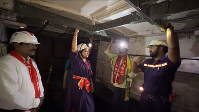 The image shows Telangana Rakshana Sena founder K Kavitha interacting with the Singareni workers inside PVK open cast coal mine in Kothagudem on Thursday, July 9, 2026.