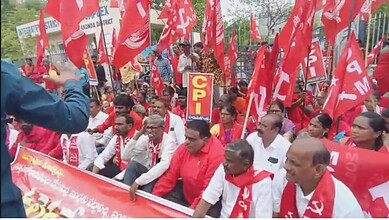 Left parties protest in Hanamkonda against hut demolitions with red flags and banners.