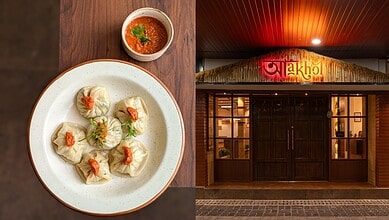 Delicious dumplings with spicy sauce served on a white plate in a restaurant setting.