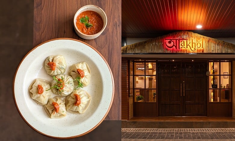 Delicious dumplings with spicy sauce served on a white plate in a restaurant setting.