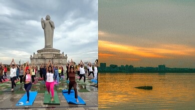 People practicing yoga at Hussain Sagar Lake on Friendship Day with Hyderabad skyline in background.