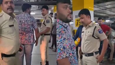 The image shows Mohd Siddique being detained by KPHB police for carrying a gun during a skirmish inside the parking lot of Lulu Mall on Sunday night, July 12, 2026.