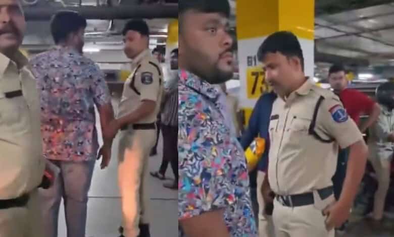 The image shows Mohd Siddique being detained by KPHB police for carrying a gun during a skirmish inside the parking lot of Lulu Mall on Sunday night, July 12, 2026.