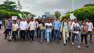 Students protest against Jauhar University demolition in Hyderabad, holding placards and banners.