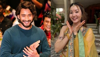 Happy man and woman in traditional attire at a cultural event in India.