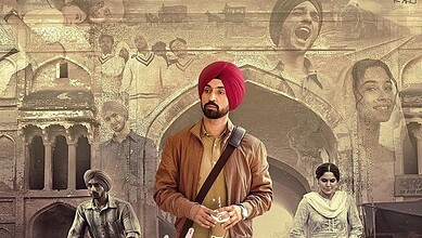 Young man in a brown leather jacket and red turban standing in front of historic architecture.