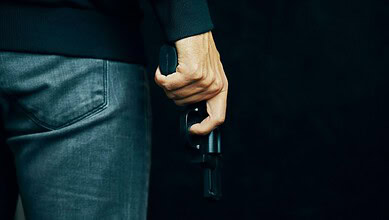Close-up of a man holding a handgun in his right hand at Lulu Mall parking lot.