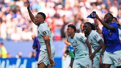 French football players celebrating during a match at the FIFA World Cup.
