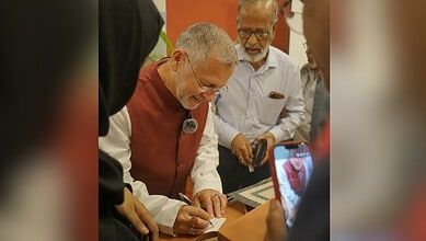 Mughal period example of religious pluralism: Michael Calabria signing a document with diverse scholars.