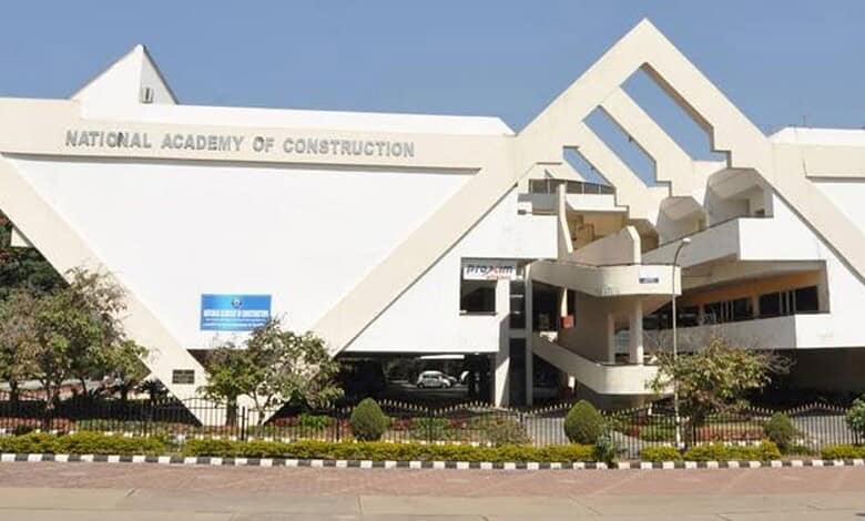 Modern white building of the National Academy of Construction with geometric design.