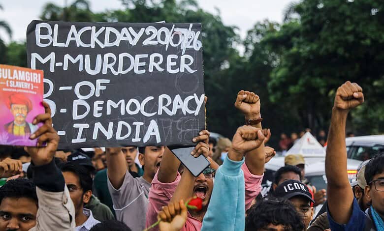 Protesters hold signs and raise fists during a demonstration in Telangana.
