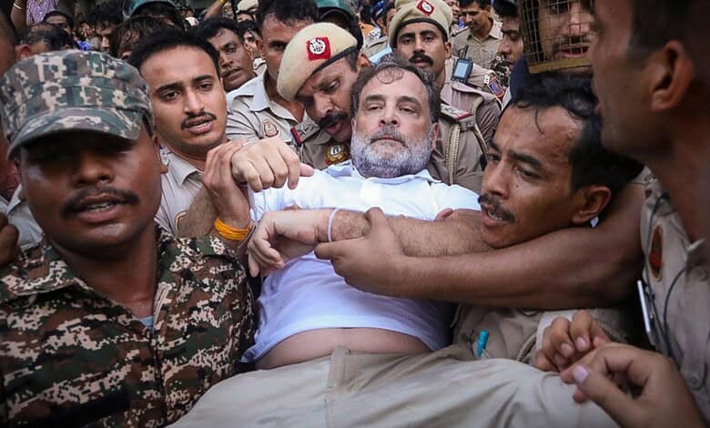 Man being forcibly removed by police and protesters during Telangana bandh protest.