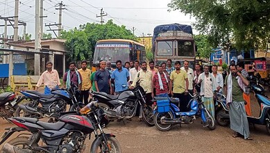 Farmers protesting with bikes and rickshaws in Nalgonda village over power cuts.