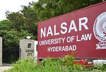 NALSAR University of Law Hyderabad entrance with greenery and justice city sign.