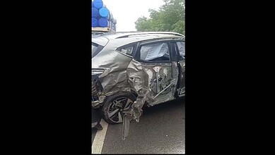 Damaged grey car after accident on Hyderabad's ORR, with visible side impact and crumpled bodywork.