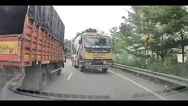 Truck driving on the wrong side of Hyderabad ORR, risking safety and traffic violations.