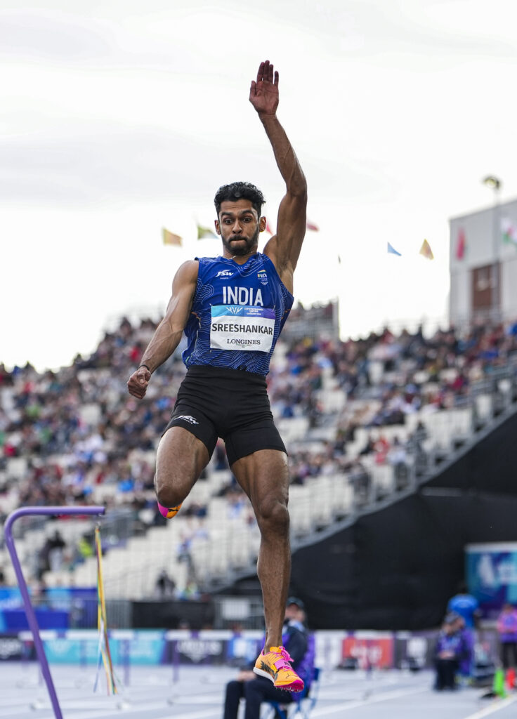 Sreeshankar in mid-air during a long jump at the Commonwealth Games.
