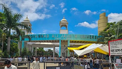 People gather outside the Mohammad Ali Jauhar University during a sit-in protest over the order for demolition of 38 buildings of the university