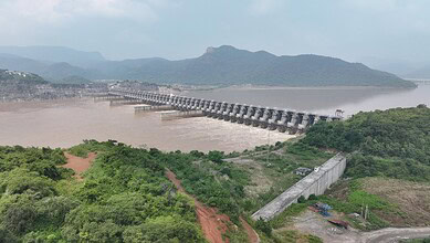 Polavaram dam on Godavari River with water reservoir and surrounding hills in India.
