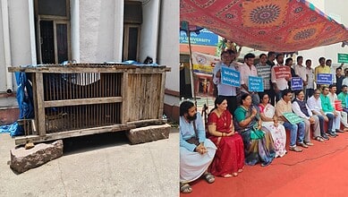 Protesters seated with placards opposing tribal art museum at a public event.