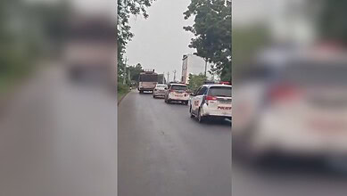 Traffic jam on a rainy day with multiple vehicles on a narrow road in Jagtial.