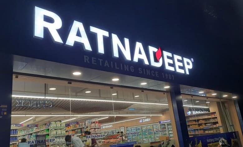 Exterior view of Ratnadeep supermarket with visible logo and interior shelves stocked with dairy products.