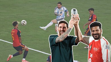 Football players celebrating on the field with a selfie during a match.