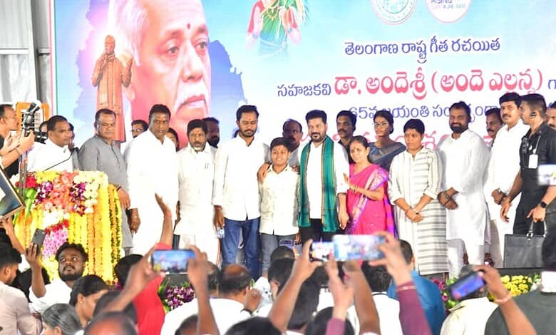 Revanth addresses Telangana youth at a political event with a large crowd and a colourful backdrop.