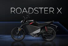 Ola Electric Roadster X electric motorcycle displayed on stage at launch event.