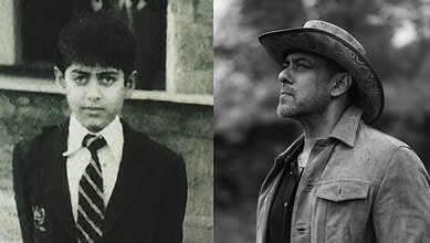 Black and white photo of a young boy in a school uniform and a man wearing a hat.
