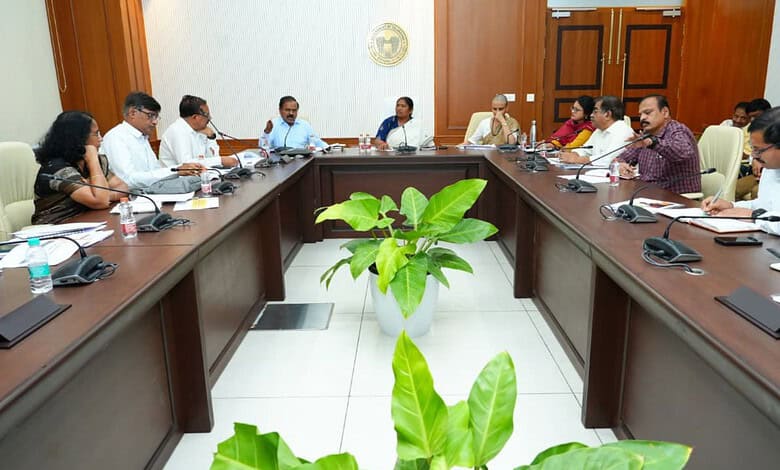 Government officials and leaders in a meeting room discussing water supply to rural areas.