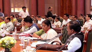 Members of parliament and officials attending a formal meeting on panchayat performance standards.