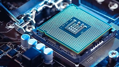 Close-up of a computer processor on a motherboard with blue lighting effects.