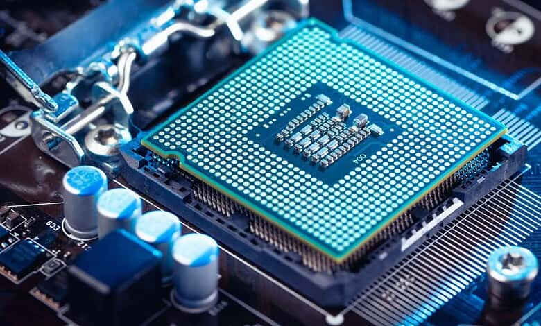 Close-up of a computer processor on a motherboard with blue lighting effects.