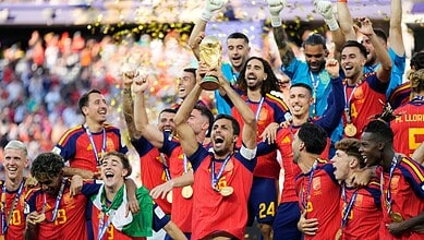 Spain football team celebrating with trophy after winning FIFA World Cup.