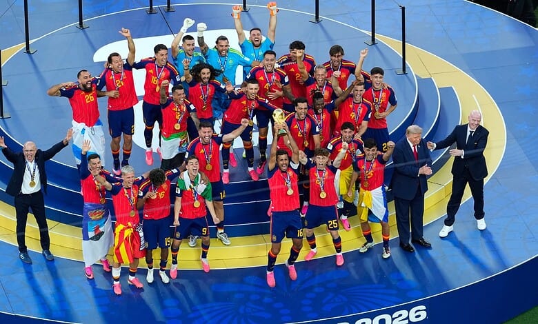 Spain's football team celebrates winning the FIFA World Cup with medals and trophies.