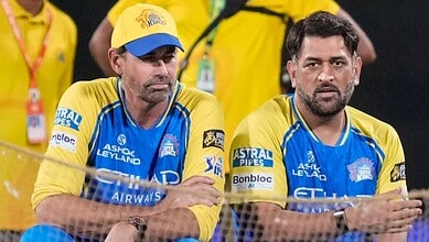 CSK coach Stephen Fleming with team members during a match, wearing yellow and blue jerseys.