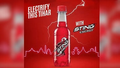 Sting Energy Drink bottle with lightning and Tihar festival theme in the background.