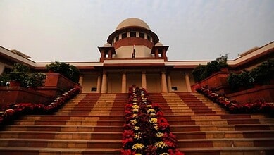 Supreme Court of India building with steps and floral decorations in New Delhi.