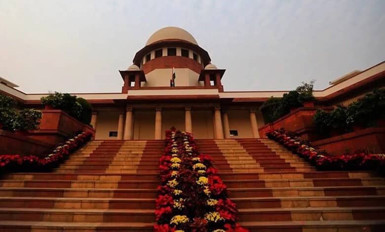 Supreme Court of India building with steps and floral decorations in New Delhi.